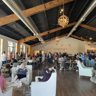 a large group of people in a tasting room