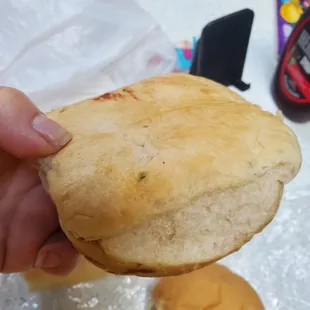 a hand holding a piece of bread