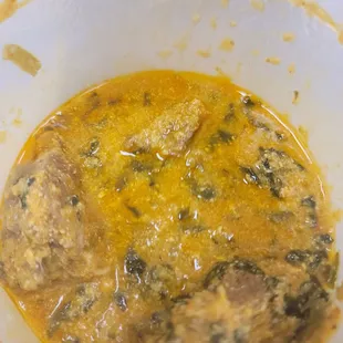 Inside the to go container of the egusi