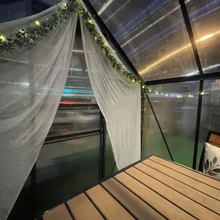 a view of a bed in a glass walled room