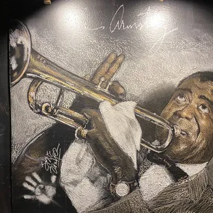 a mural of a man playing a trumpet