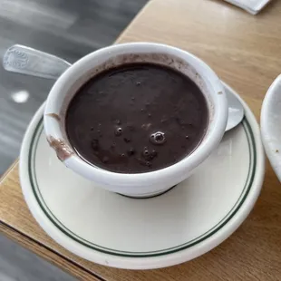 a cup of hot chocolate and a plate of bananas