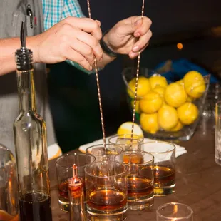 a bartender preparing a drink at a bar