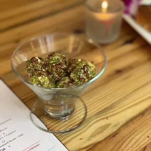 a glass bowl of food on a wooden table