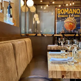 a long table with wine glasses and place settings