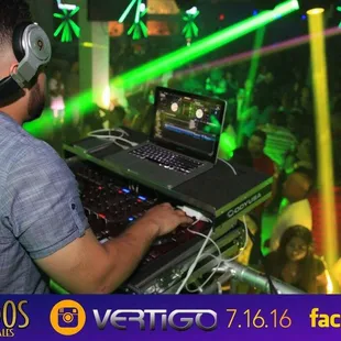 a dj using a laptop and headphones