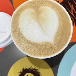 a cup of cappuccino with a lion on it