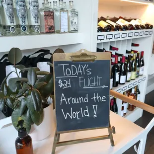 a chalk board with a sign that says today's by flight around the world