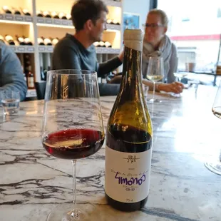 a bottle of wine and a glass of wine