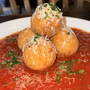 Suppli (crispy risotto balls filled with different kinds of cheese)