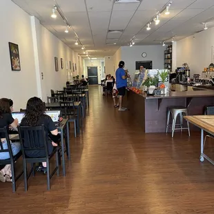 people sitting at tables in a coffee shop