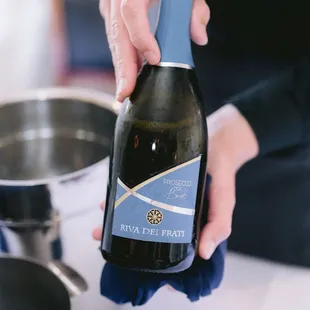 a person holding a bottle of wine