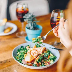 a woman eating a salad with a fork