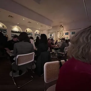 people sitting at tables in a restaurant