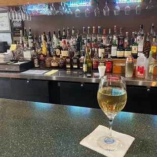 a glass of wine on the bar