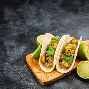 three tacos on a cutting board