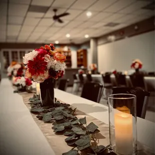 a long table with flowers and candles
