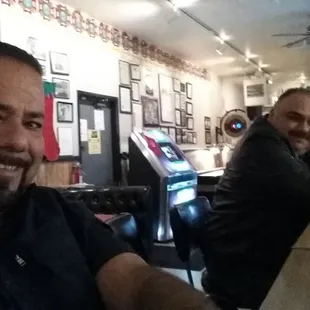 two men sitting at a bar