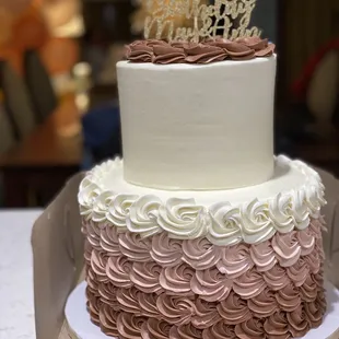 2 tier cake with ombré rose gold rosettes