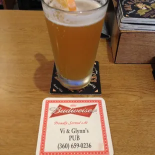 a glass of beer with a slice of orange