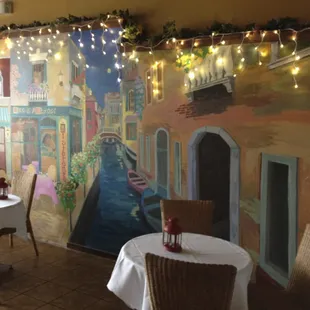 a restaurant with a mural on the wall