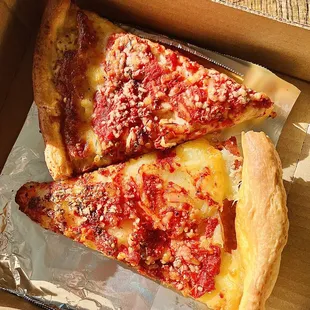 two slices of pizza in a box