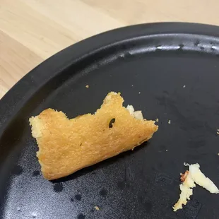 Plastic piece on the bottom of the pizza