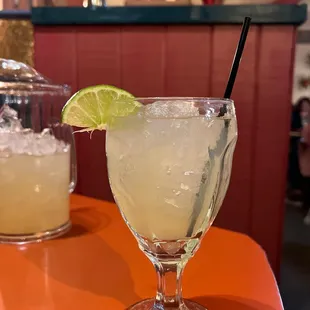 a margarita with a lime wedge