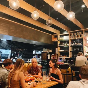 a group of people sitting at a table in a restaurant