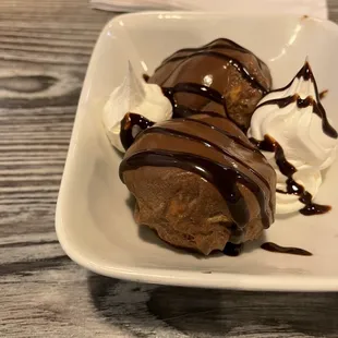 Cream puffs bathed in chocolate