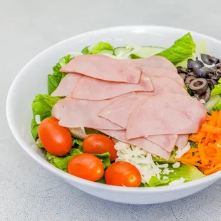 a salad with ham and vegetables