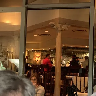 people sitting at tables in a restaurant