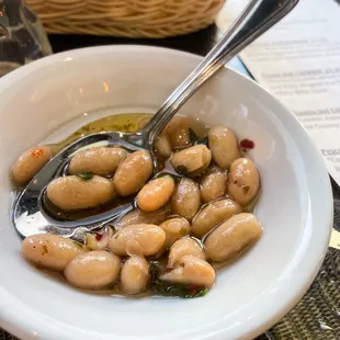 a bowl of beans with a spoon