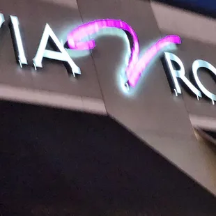 a neon sign on the side of a building