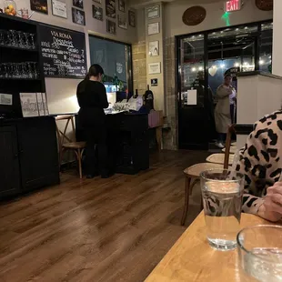 a woman sitting at a table in a restaurant