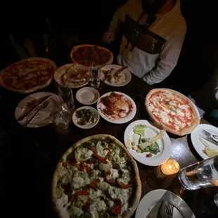 a table full of pizzas