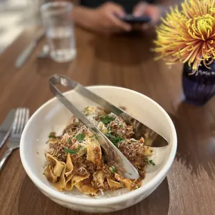 a plate of pasta with meat and cheese