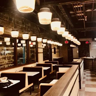 a row of tables and booths in a restaurant