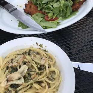 Garlic and olive oil side pasta in the background chicken Milanese