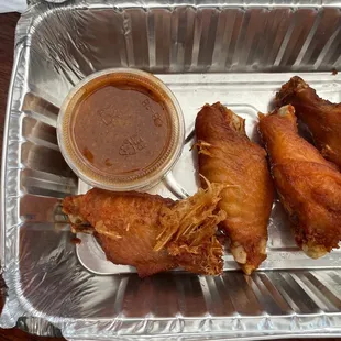 Over cooked wings with feathers still in the chicken.