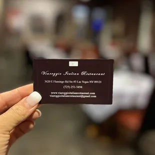  hand holding a business card