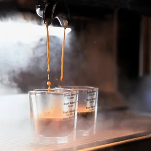 espresso being poured into cups