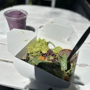 a salad in a take out box