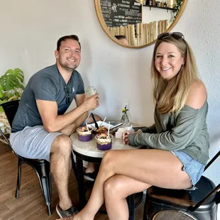 ows a man and a woman sitting at a table