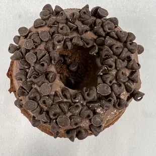a chocolate donut with chocolate chips