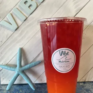 a glass of juice next to a starfish