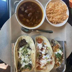 Barbacoa, Buffalo Chicken Taco, Smoked Out Brisket Taco with corn tortilla, rice and beans (beans have bacon)