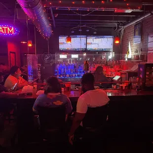 people sitting at a bar