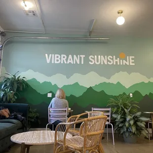 a woman sitting at a table in a coffee shop