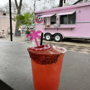 a drink in a plastic cup on a table